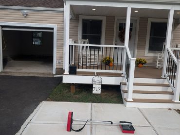 Sweep equipment on a concrete patio in front of a home